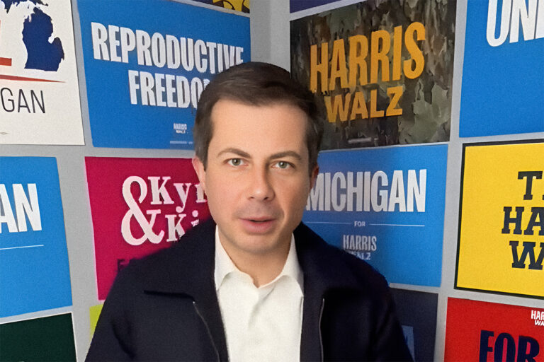 Pete Buttigieg with michigan and Harris Walz campaign signs